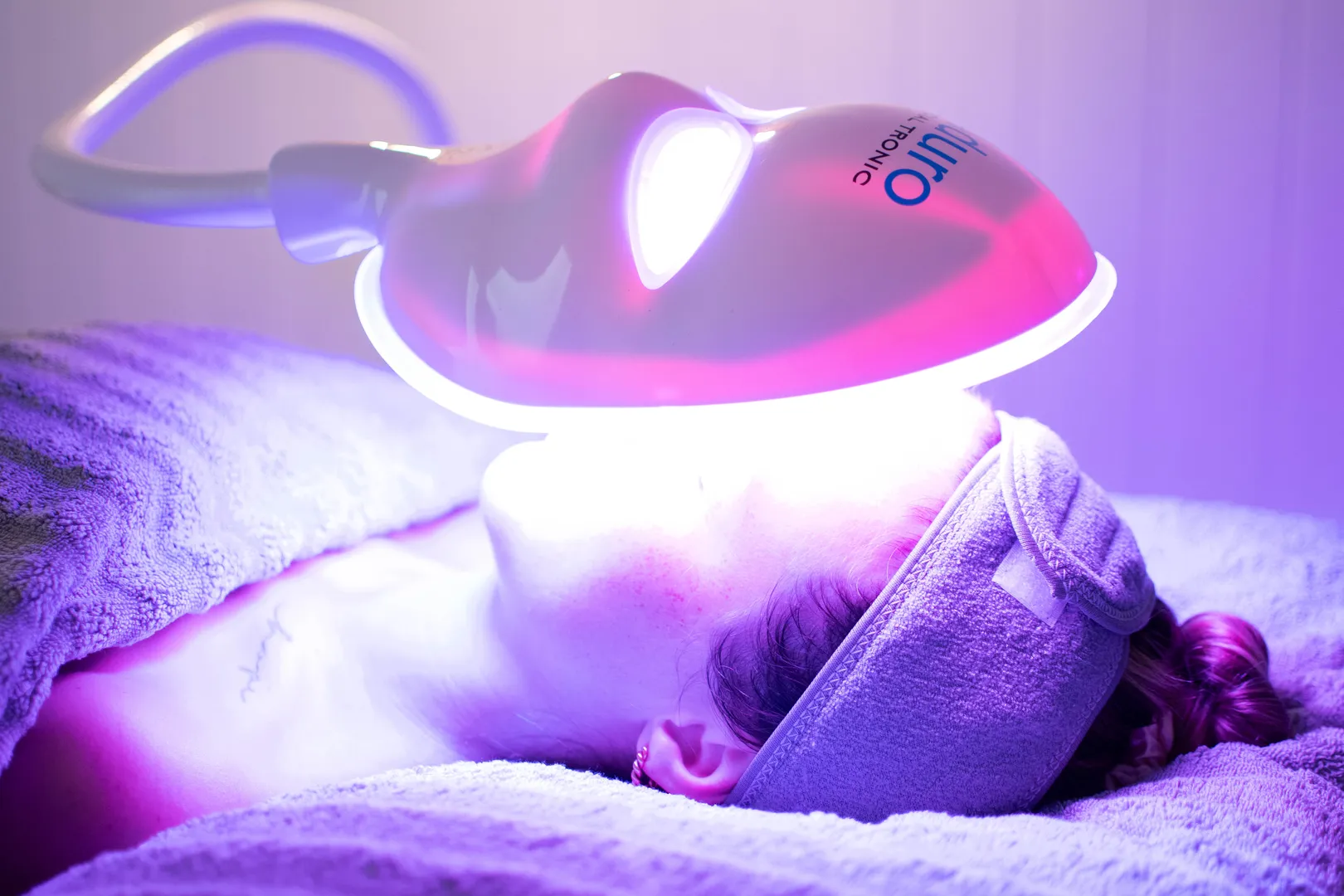 Person receiving LED light therapy treatment.